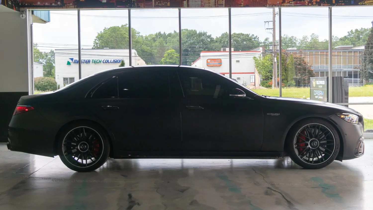 Matte black Mercedes-AMG S63 E Performance rental in Detroit, side profile