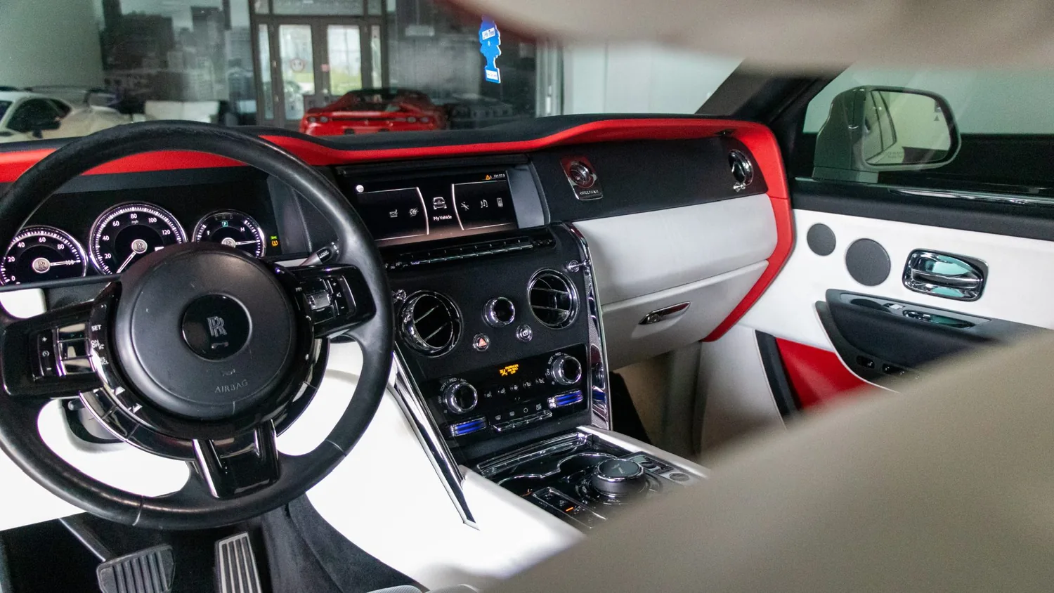 White Rolls-Royce Cullinan rental in Detroit, dashboard with red and white trim
