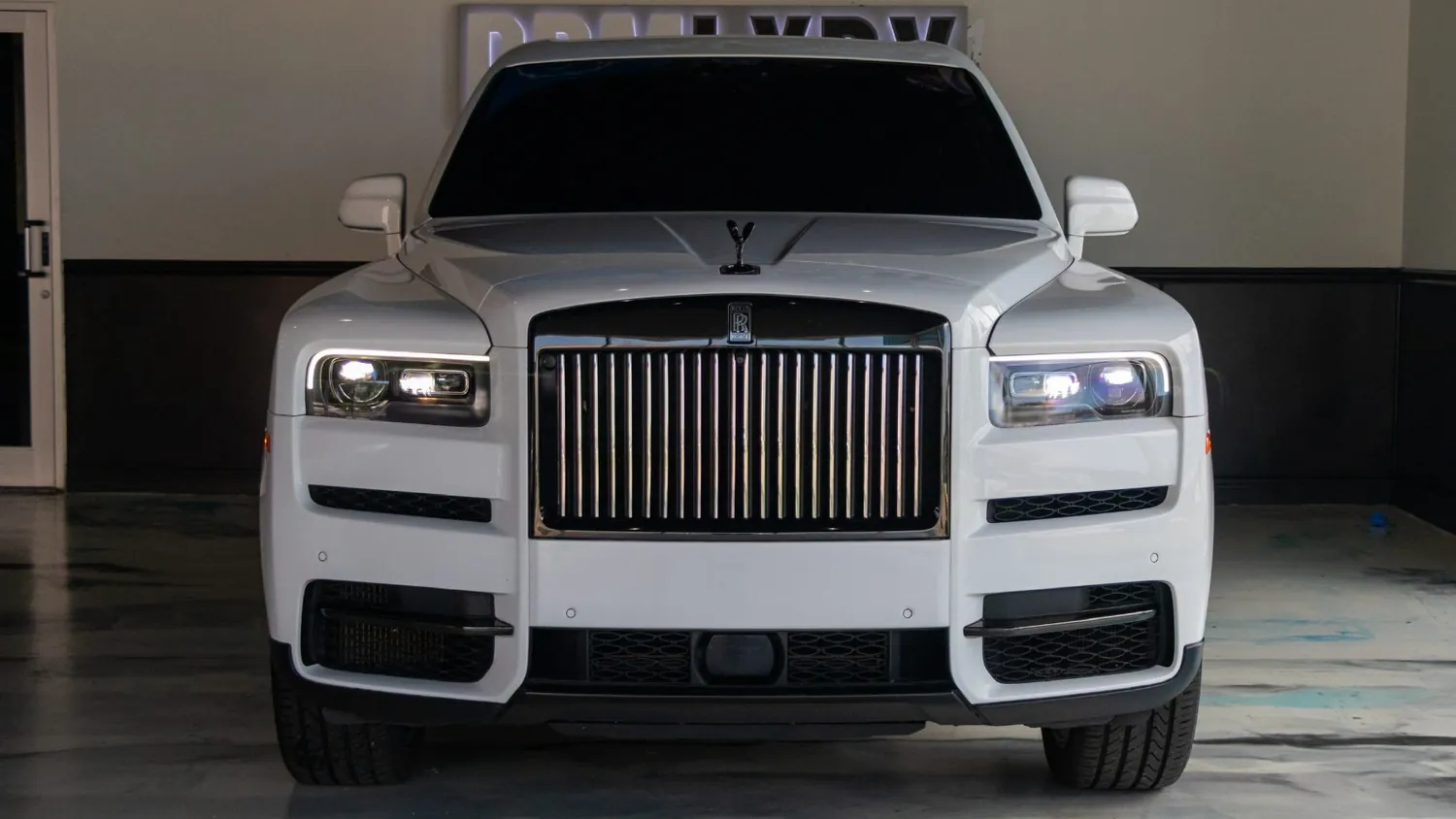 White Rolls-Royce Cullinan rental in Detroit, front grille and headlights