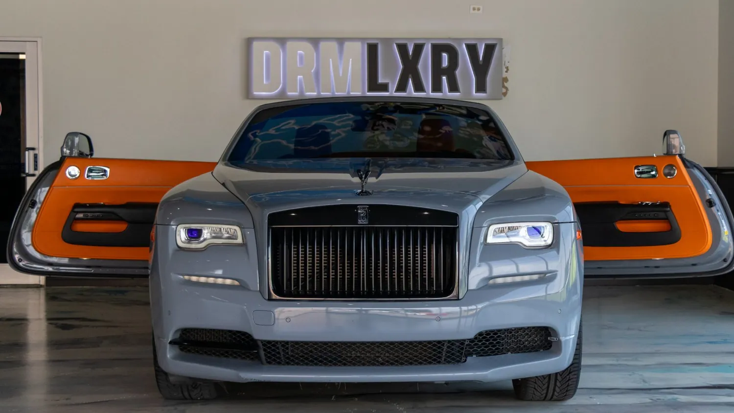Silver Rolls-Royce Dawn rental in Detroit, front view with the door open
