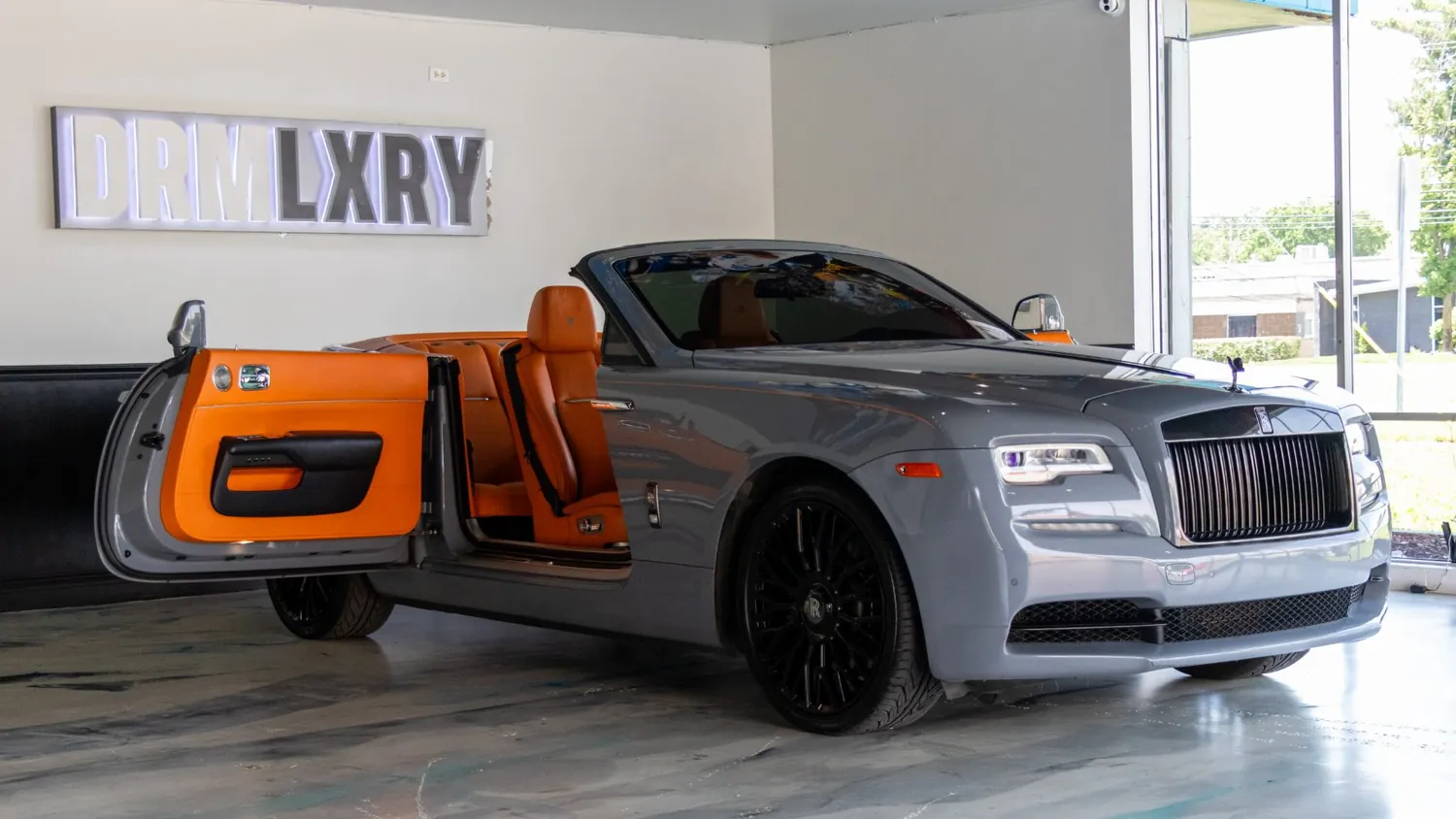 Silver Rolls-Royce Dawn rental in Detroit, side profile with the door open