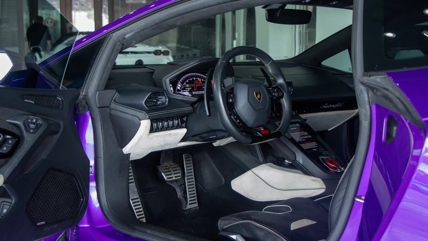 Purple Lamborghini Huracán EVO rental in Detroit, cockpit with the door open