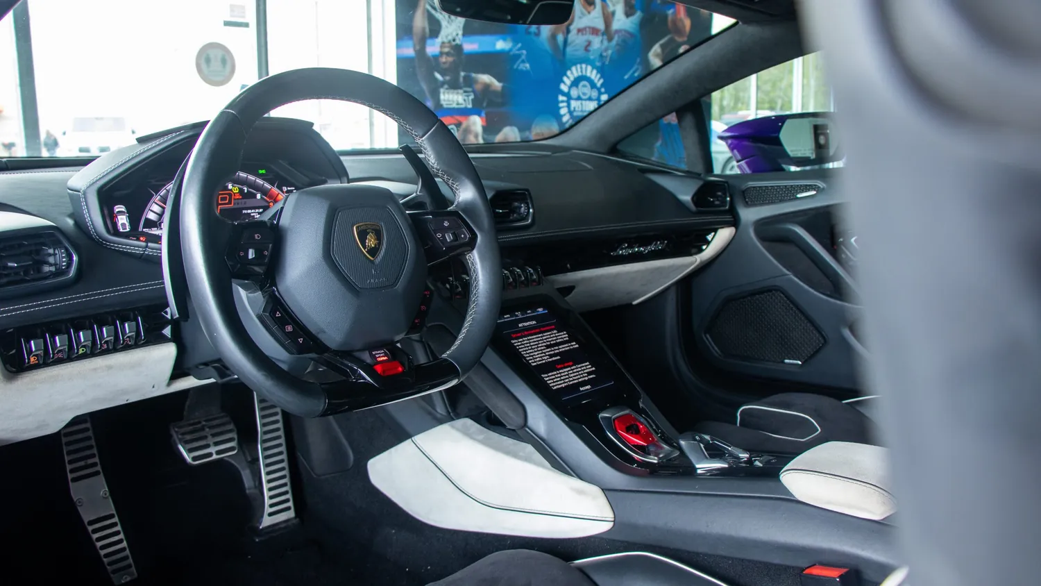 Purple Lamborghini Huracán EVO rental in Detroit, steering wheel and cockpit