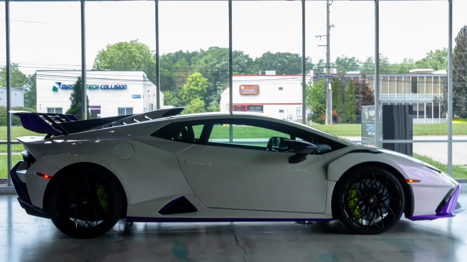 White Lamborghini Huracán STO rental in Detroit, side profile