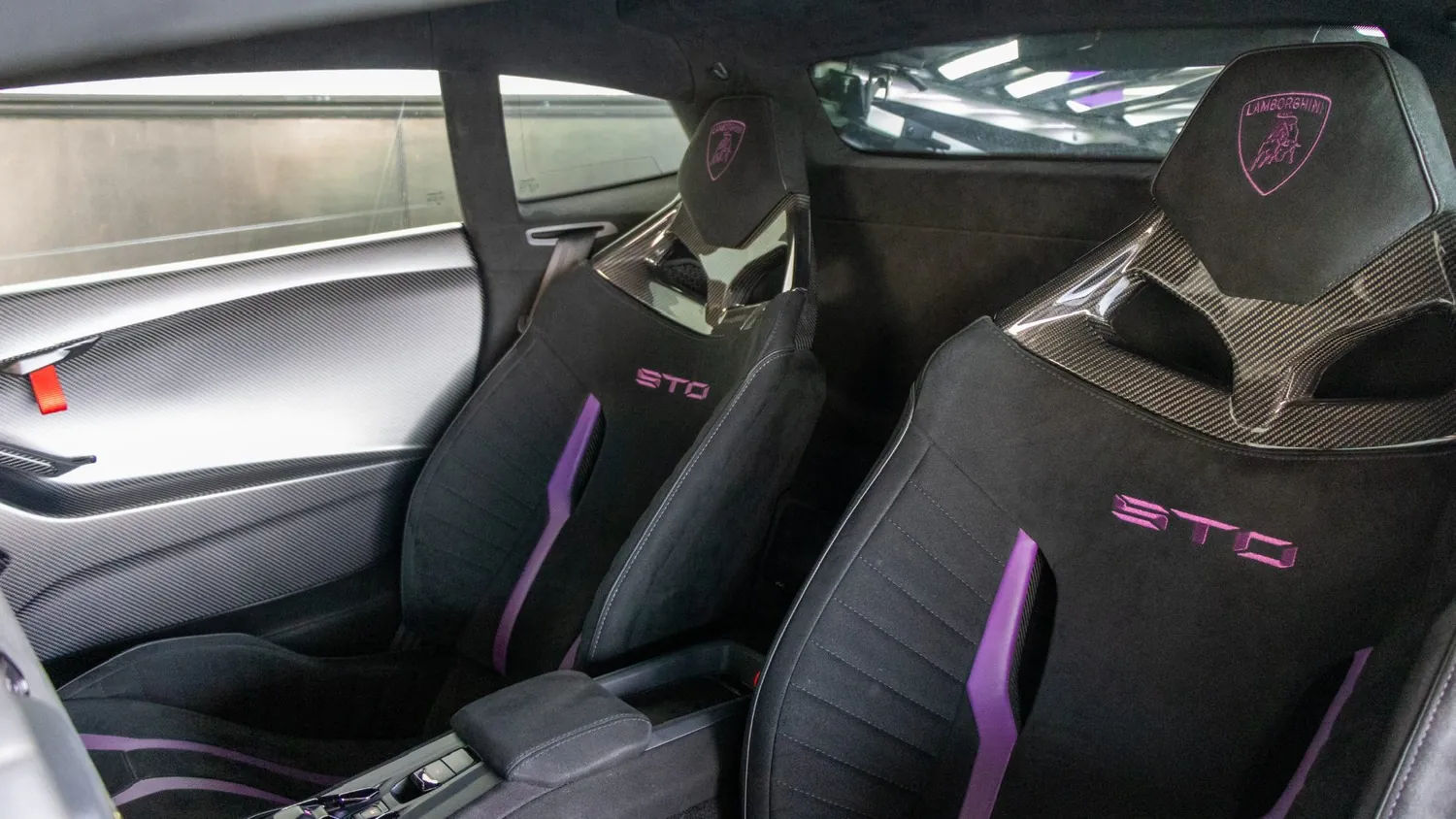 White Lamborghini Huracán STO rental in Detroit, sport seats with purple stitching
