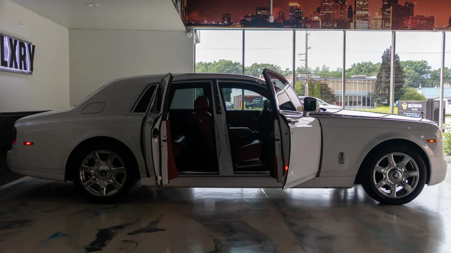 White 2017 Rolls-Royce Phantom rental in Detroit, side profile with the coach doors open