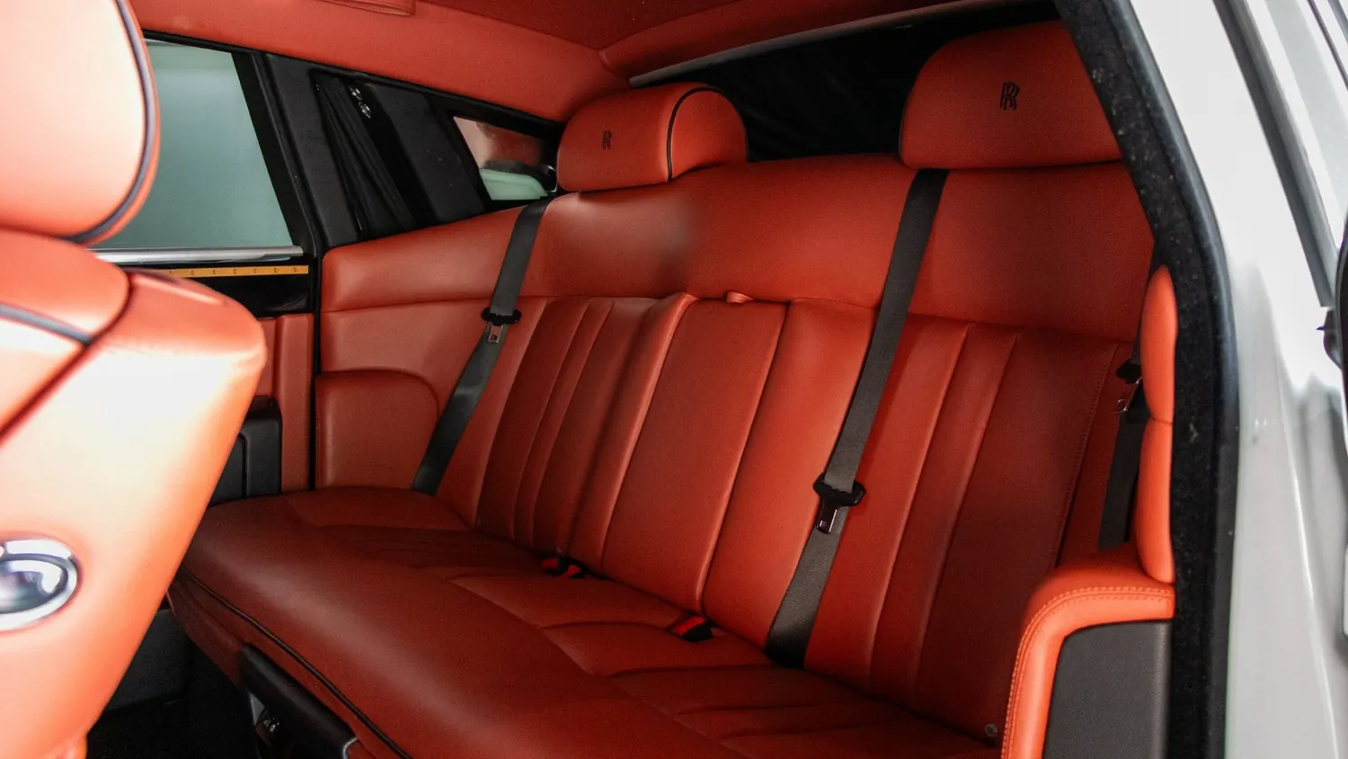 White 2017 Rolls-Royce Phantom rental in Detroit, rear seats in red leather