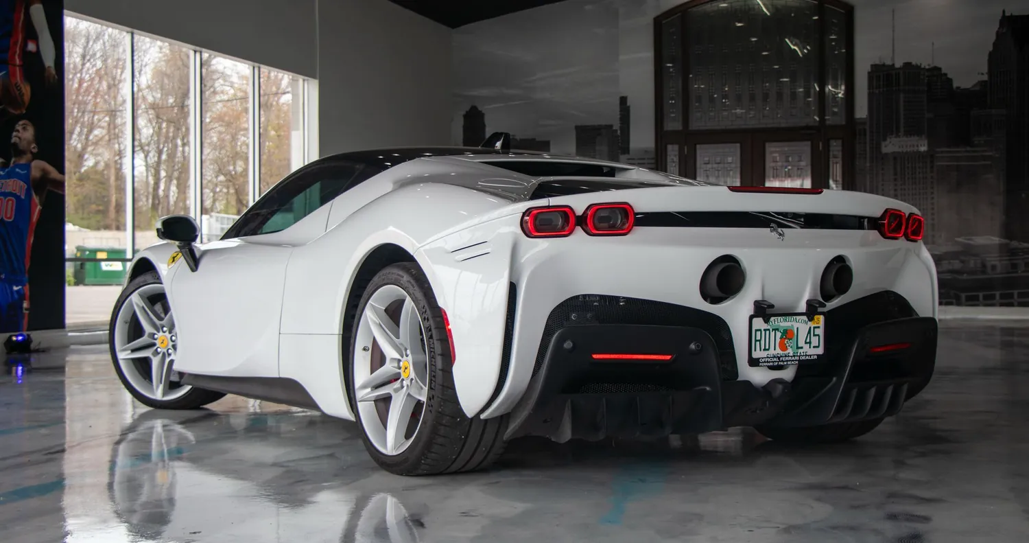 White Ferrari SF90 Stradale rental in Detroit, rear three-quarter view