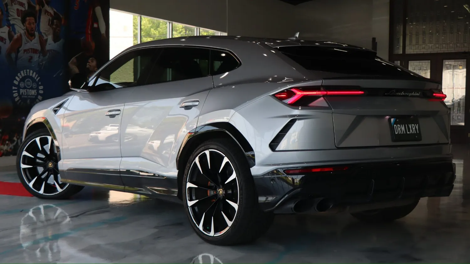 Gray 2022 Lamborghini Urus rental in Detroit, rear three-quarter view