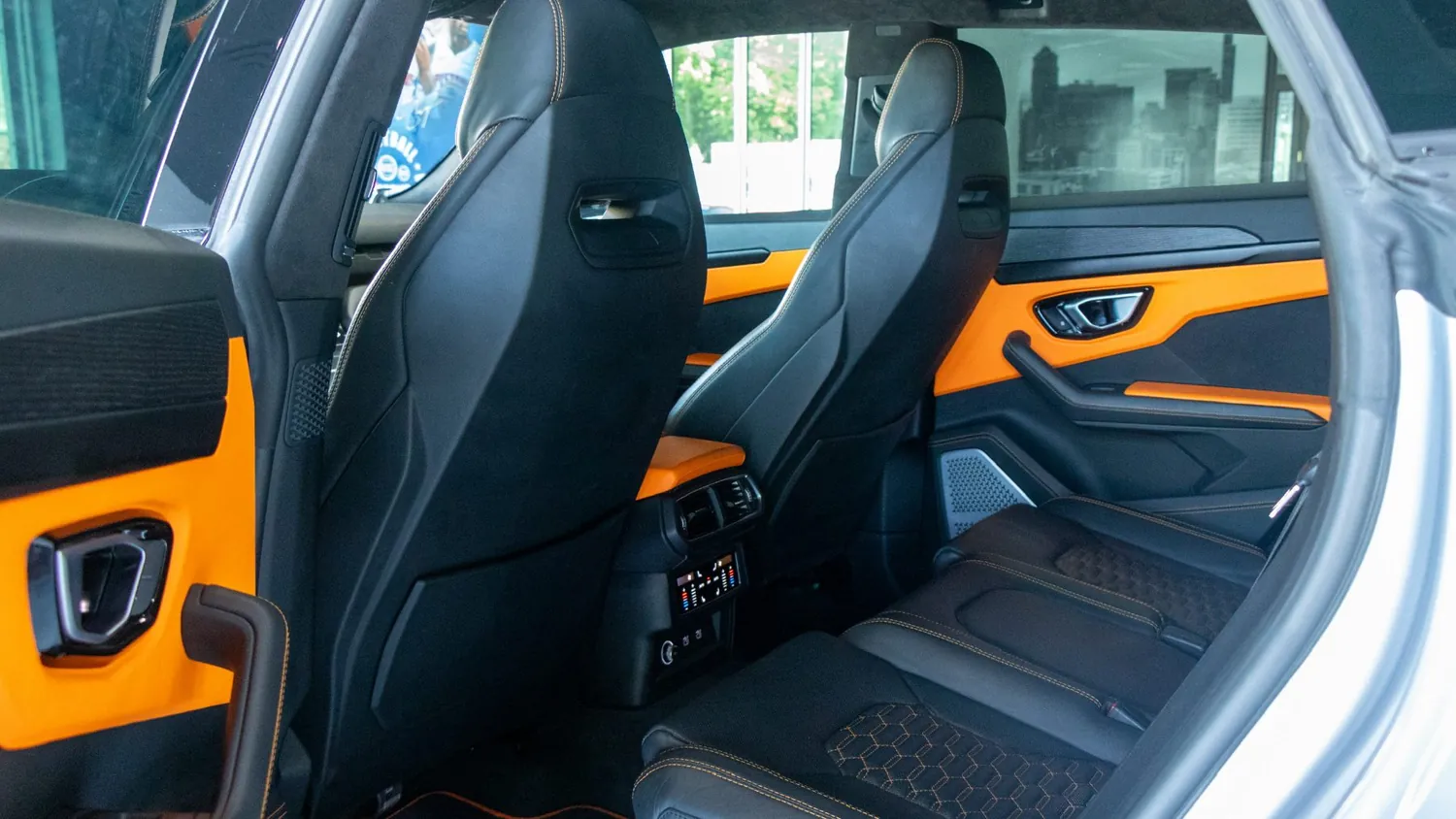 Gray 2022 Lamborghini Urus rental in Detroit, rear seats and door trim