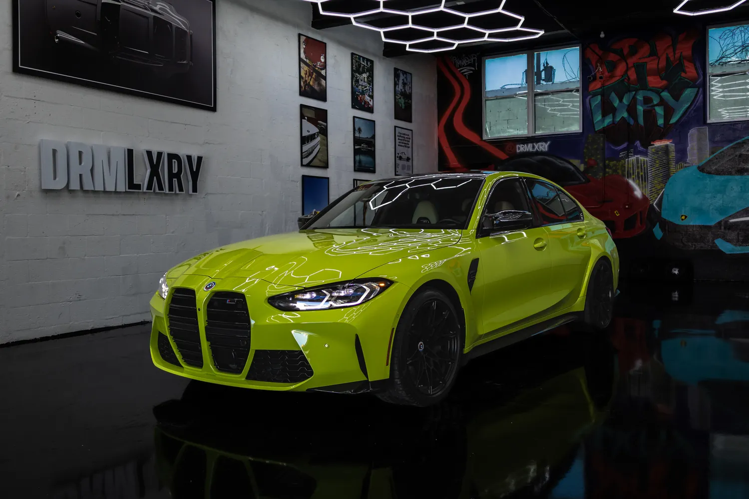 São Paulo Yellow 2023 BMW M3 Competition, front three-quarter view facing left, in the DRMLXRY Miami showroom