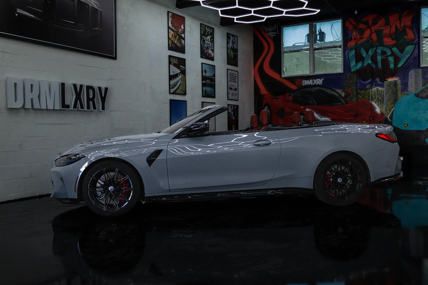 Side profile of the grey BMW M4 Competition Convertible with the top down