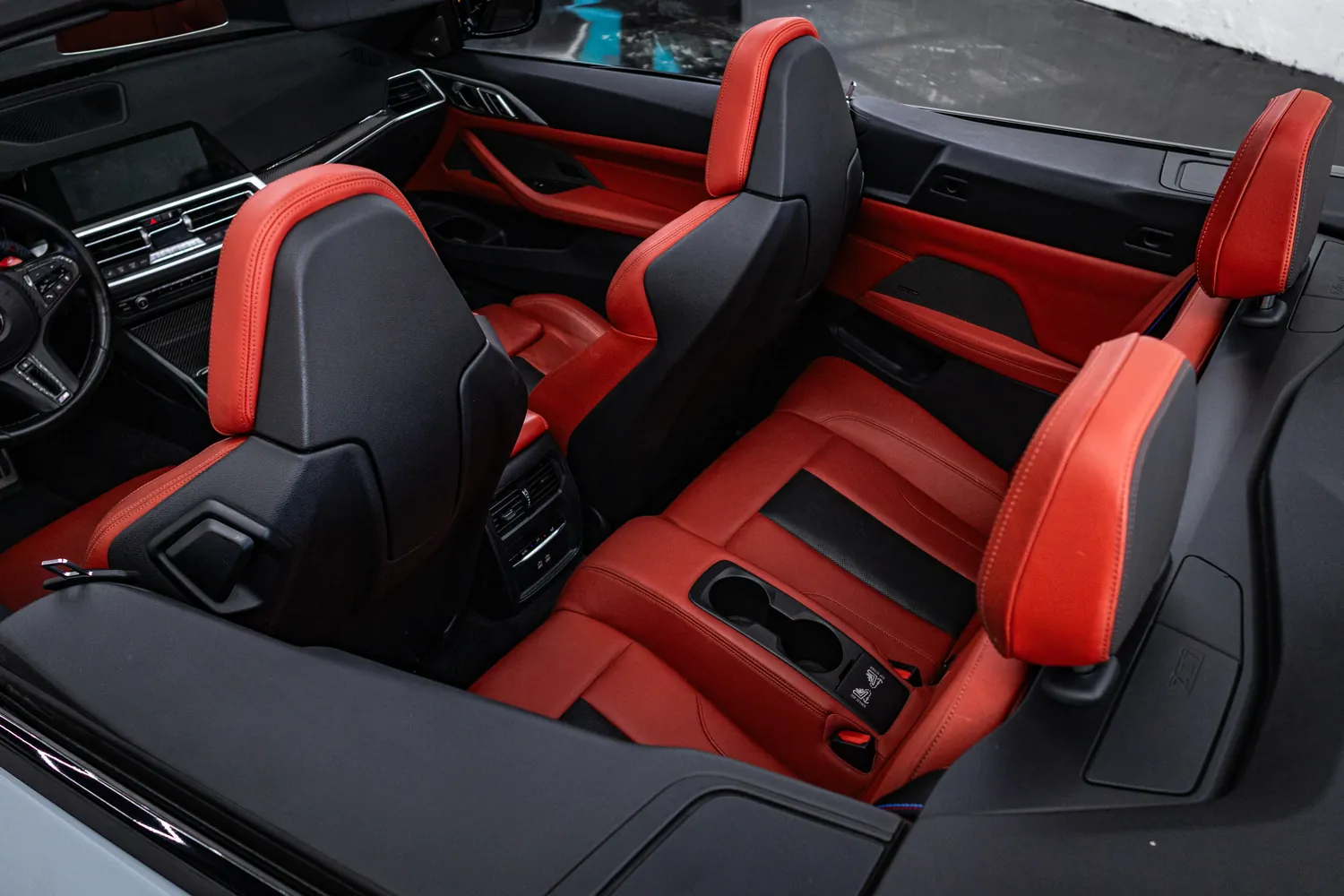 Red leather cabin of the BMW M4 Competition Convertible with the top down