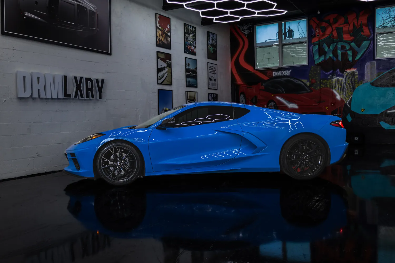 Side profile of the blue Corvette Stingray coupe with its mid-engine intakes