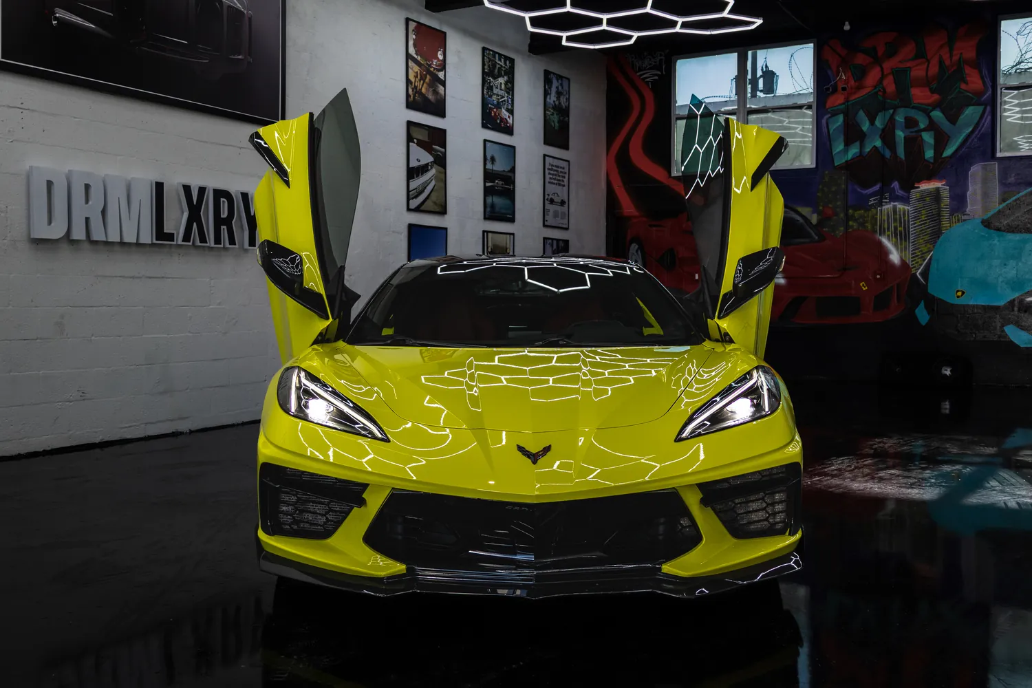 Front view of the yellow Corvette Stingray with both vertical doors raised