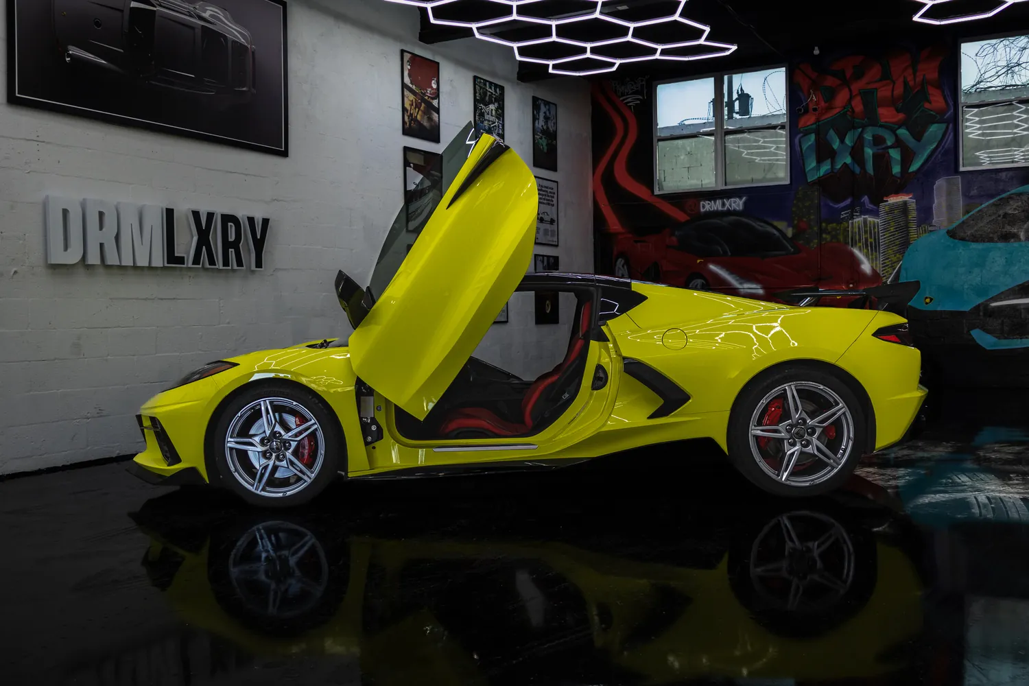 Side profile of the yellow Corvette Stingray with a vertical door raised