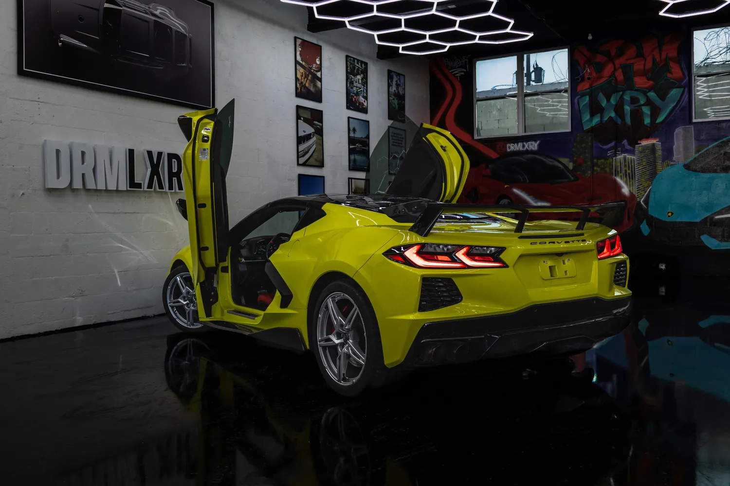 Yellow Corvette Stingray, rear three-quarter view with the doors up