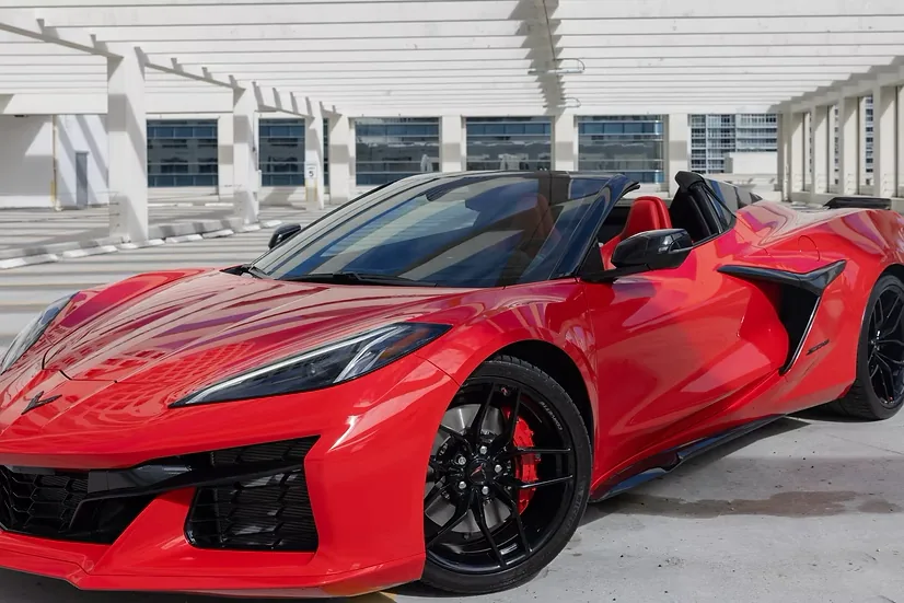 Red Corvette Z06 Convertible with the top down and red seats visible