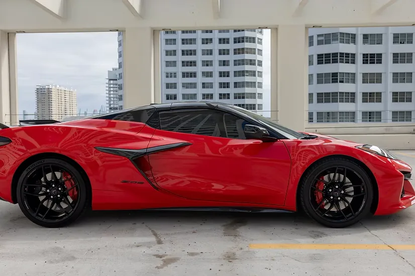 Side profile of the red Corvette Z06 with its mid-engine side intakes
