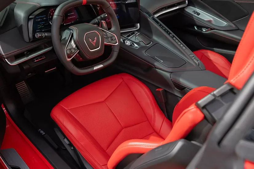 Corvette Z06 cockpit with red leather seats and digital instrument cluster