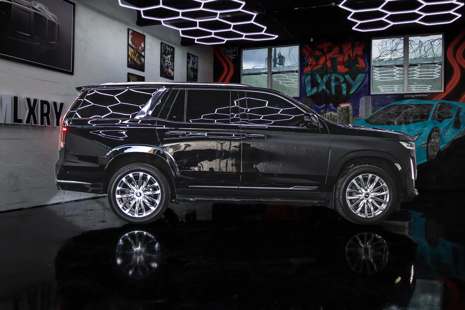 Side profile of the black Cadillac Escalade