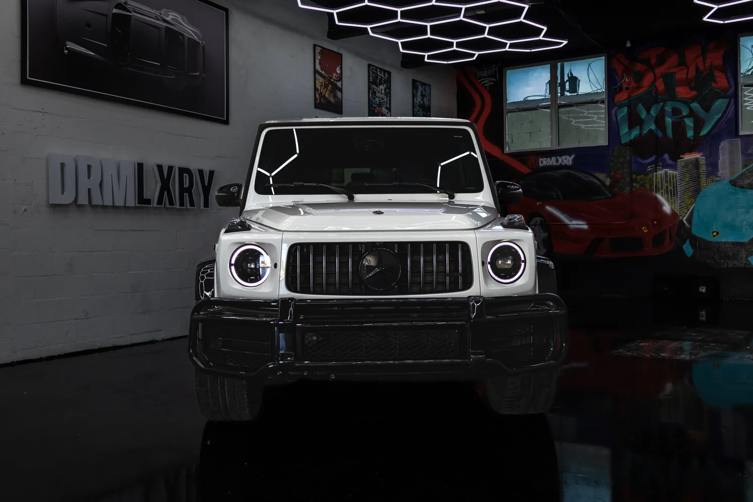 Front view of the white Mercedes-AMG G63 with round headlights and AMG grille