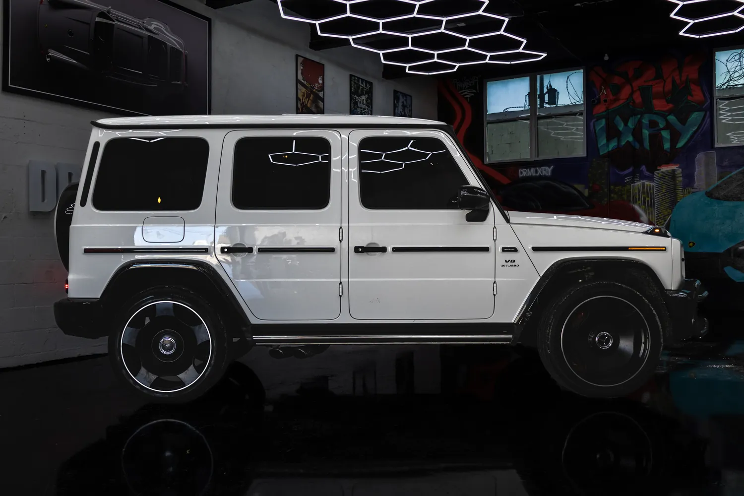 Side profile of the white Mercedes-AMG G63 with black wheels