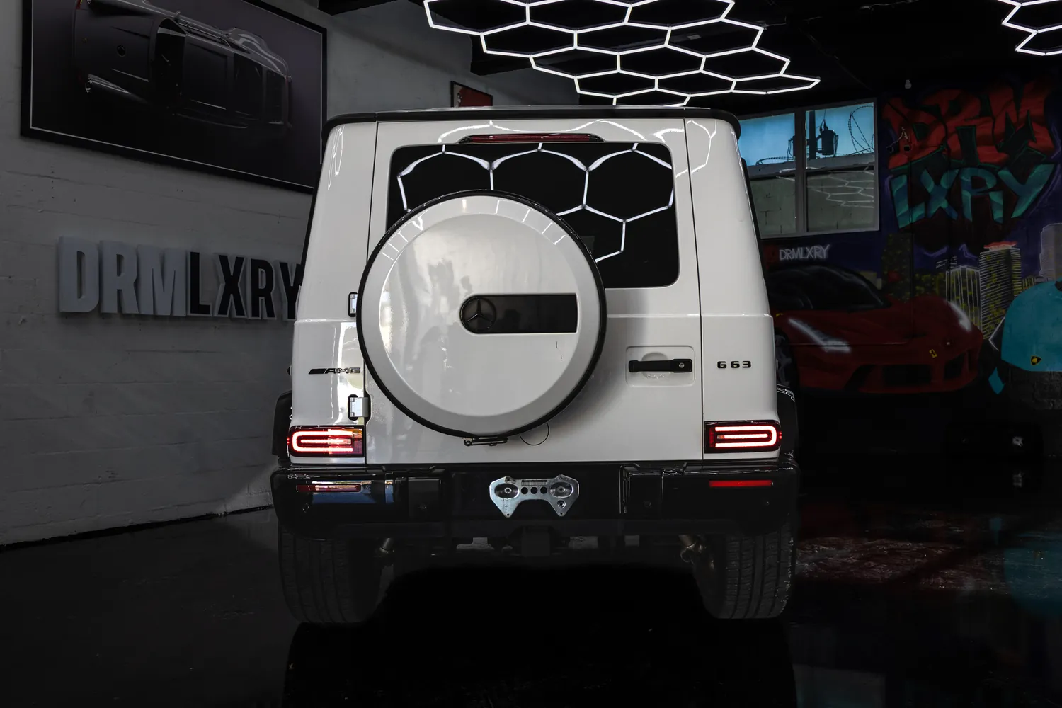 Rear of the white Mercedes-AMG G63 with its white spare wheel cover
