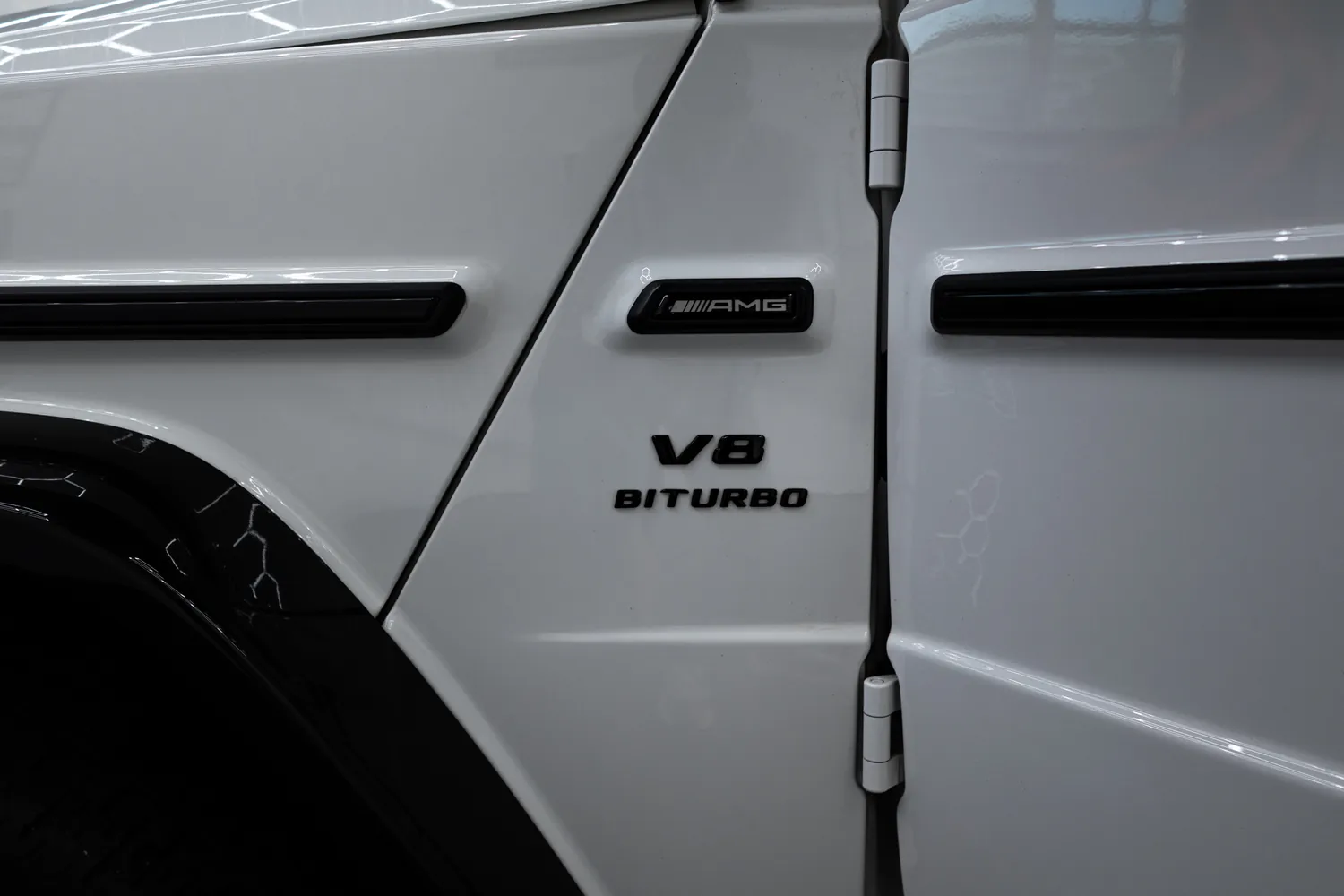 V8 Biturbo and AMG badges on the white G63's front fender