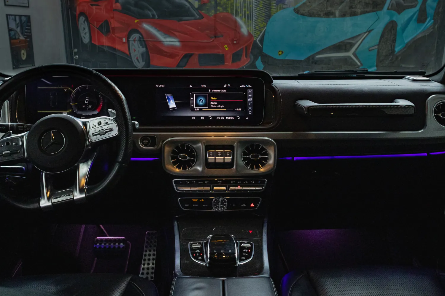 Mercedes-AMG G63 dashboard with widescreen display and ambient lighting