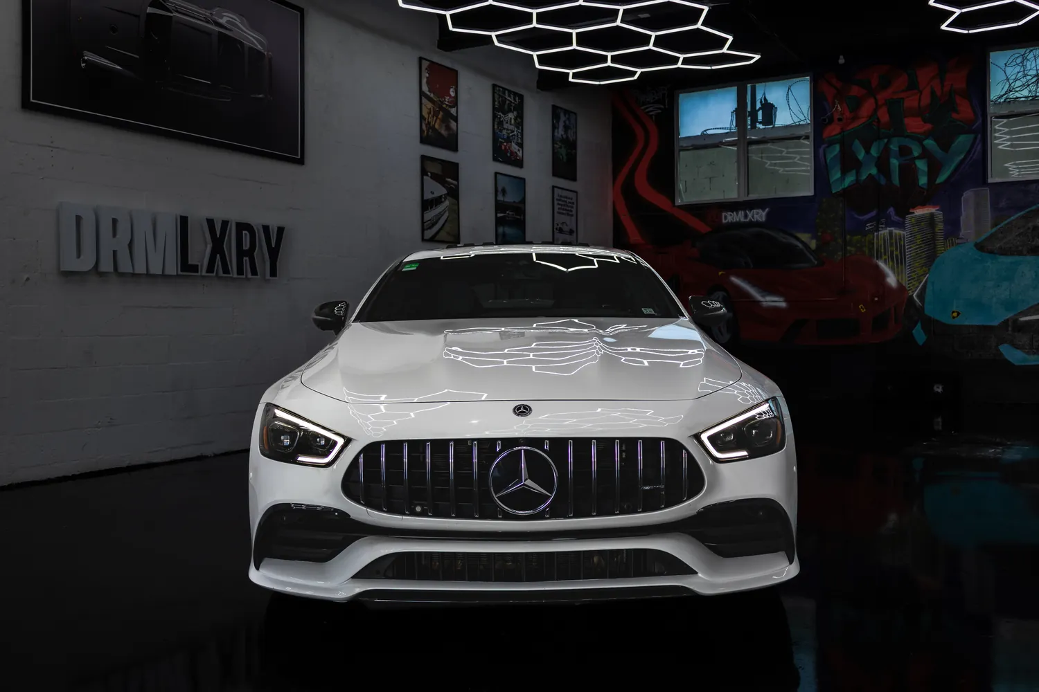 Front view of the white Mercedes-AMG GT53 with its vertical-slat AMG grille