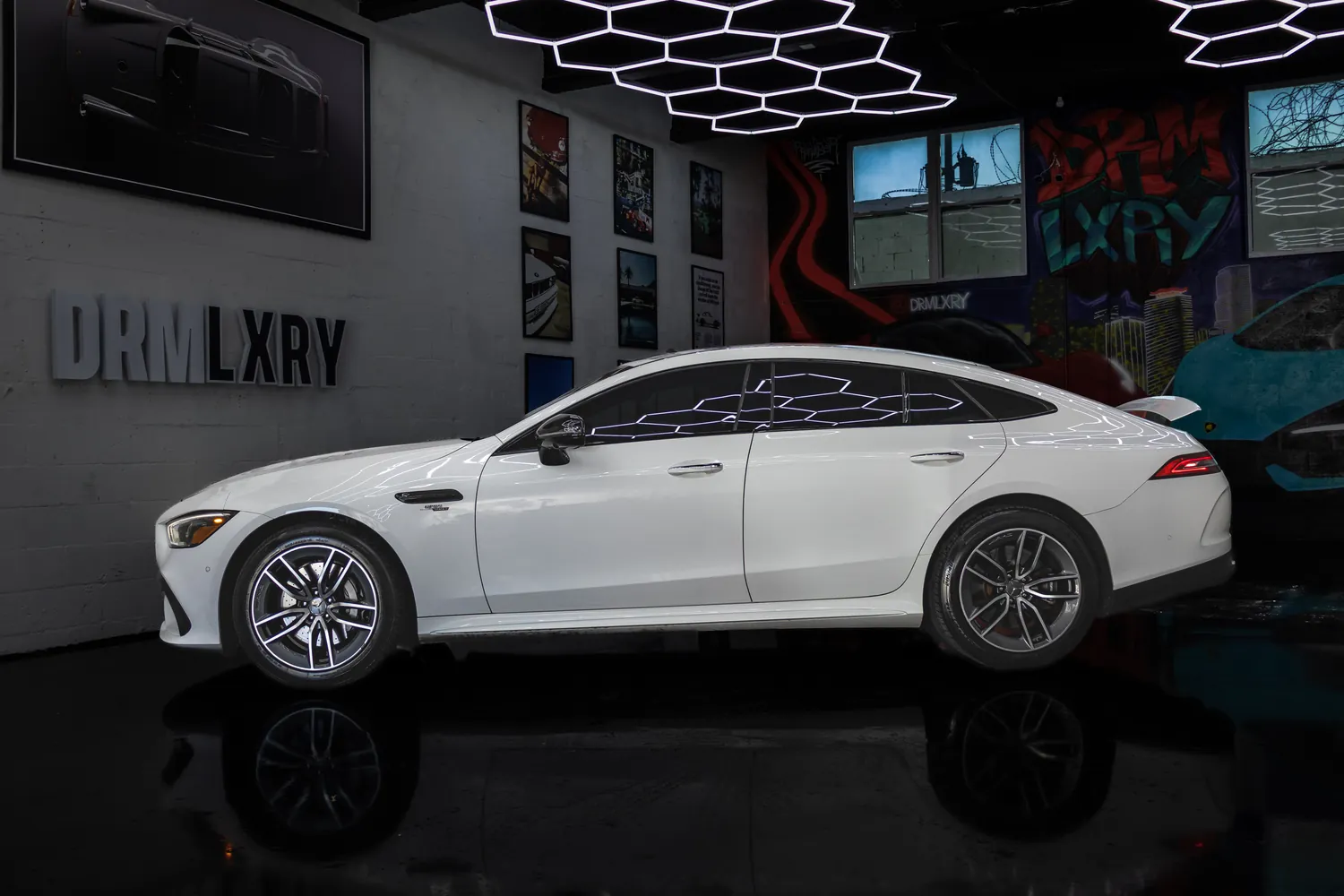 Side profile of the white Mercedes-AMG GT53 four-door coupe