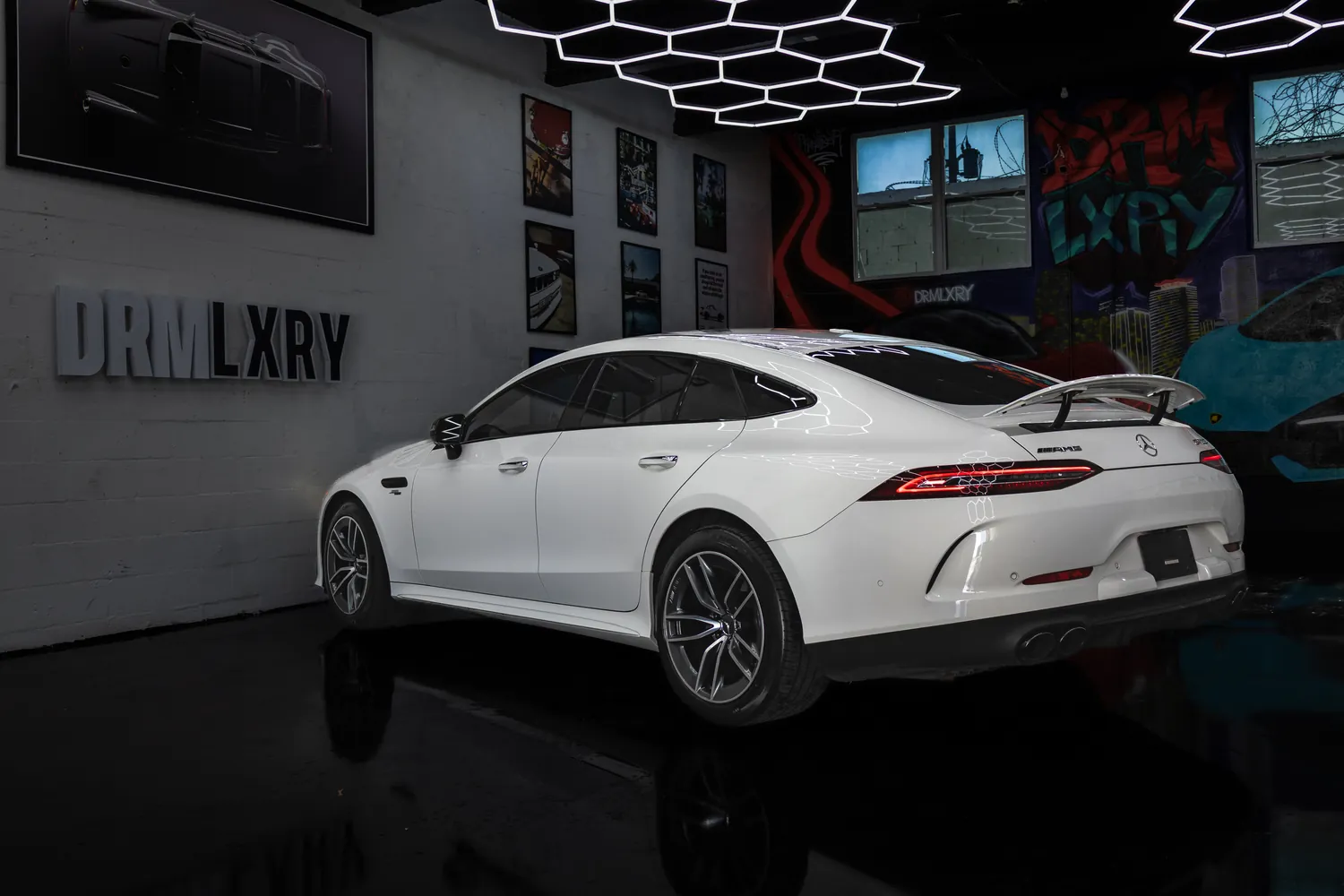 White Mercedes-AMG GT53, rear three-quarter view from the right