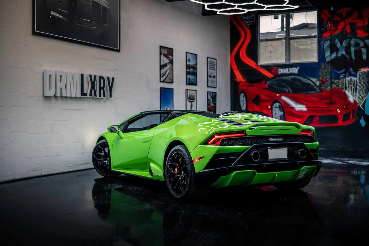 Green Lamborghini Huracán EVO Spyder, rear three-quarter view with the top down