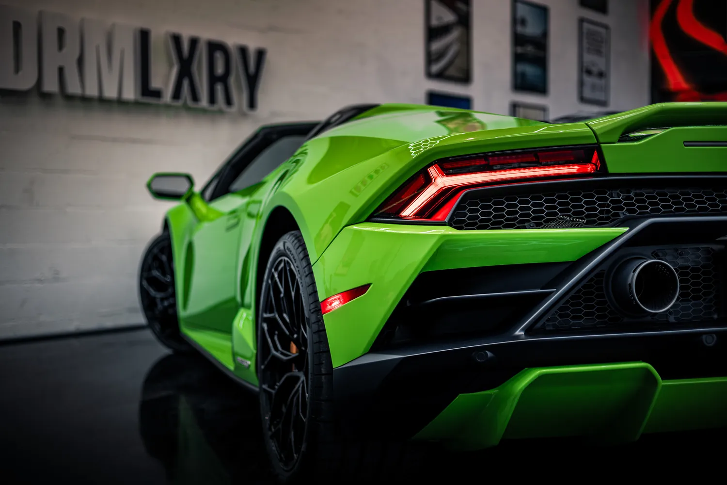 Rear taillights and exhaust of the green Lamborghini Huracán EVO Spyder