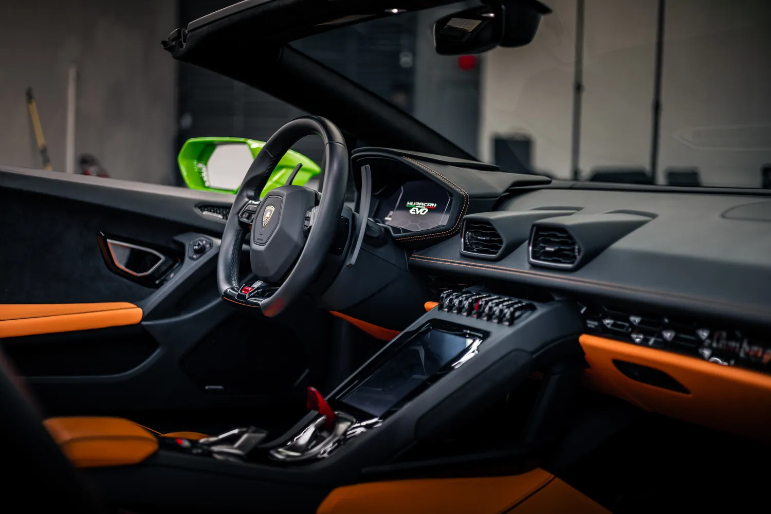 Lamborghini Huracán EVO Spyder dashboard with orange trim and center touchscreen