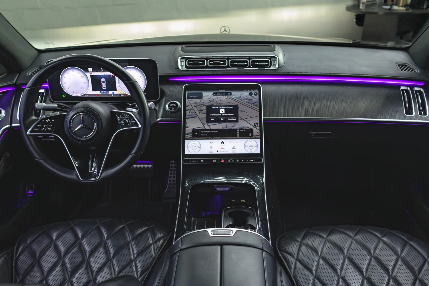 Mercedes-Benz S580 dashboard with its large center touchscreen and ambient lighting