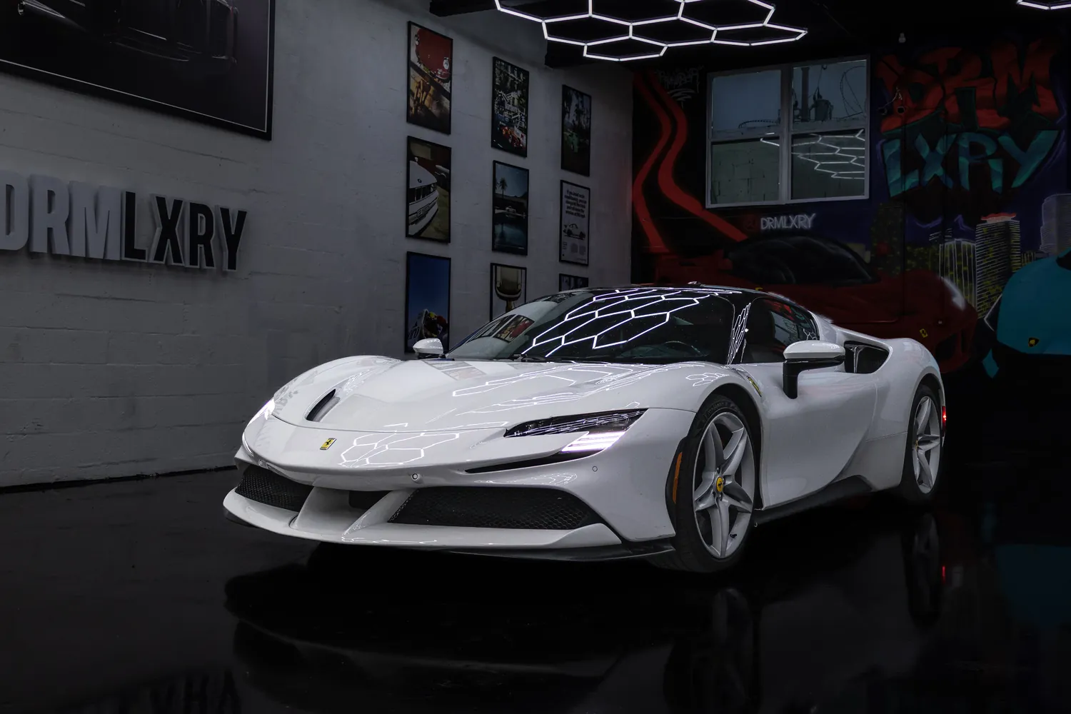 White 2023 Ferrari SF90 Stradale, front three-quarter view facing left, in the DRMLXRY Miami showroom