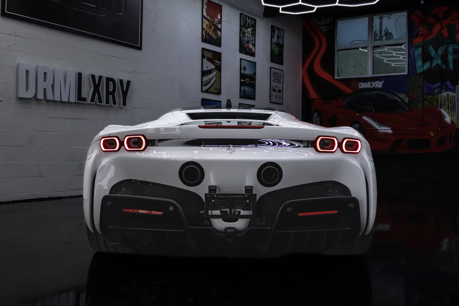 Rear of the white Ferrari SF90 Stradale with its twin round taillights