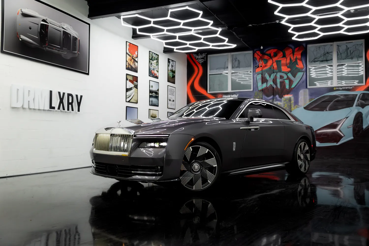 Grey 2025 Rolls-Royce Spectre, front three-quarter view facing left, in the DRMLXRY Miami showroom