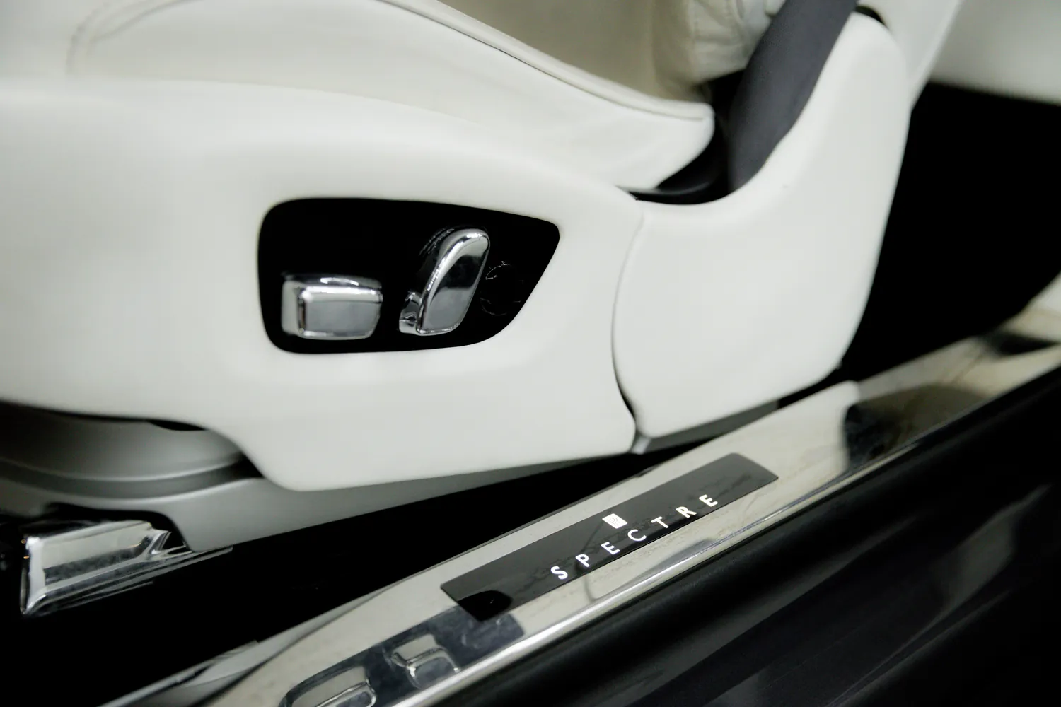 Illuminated Spectre door sill and white leather seat