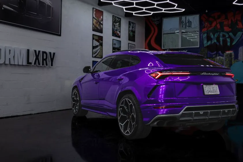 Purple Lamborghini Urus, rear three-quarter view