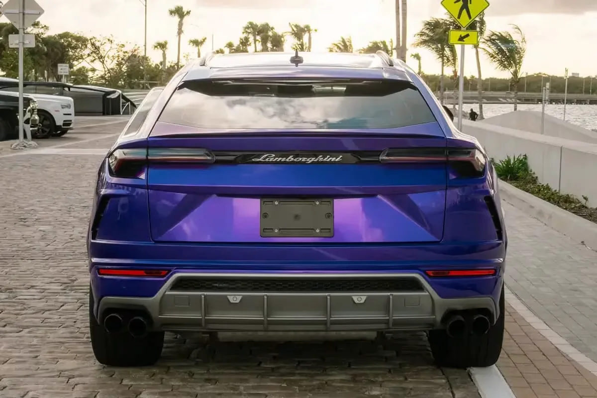 Rear of the purple Lamborghini Urus on a Miami waterfront street